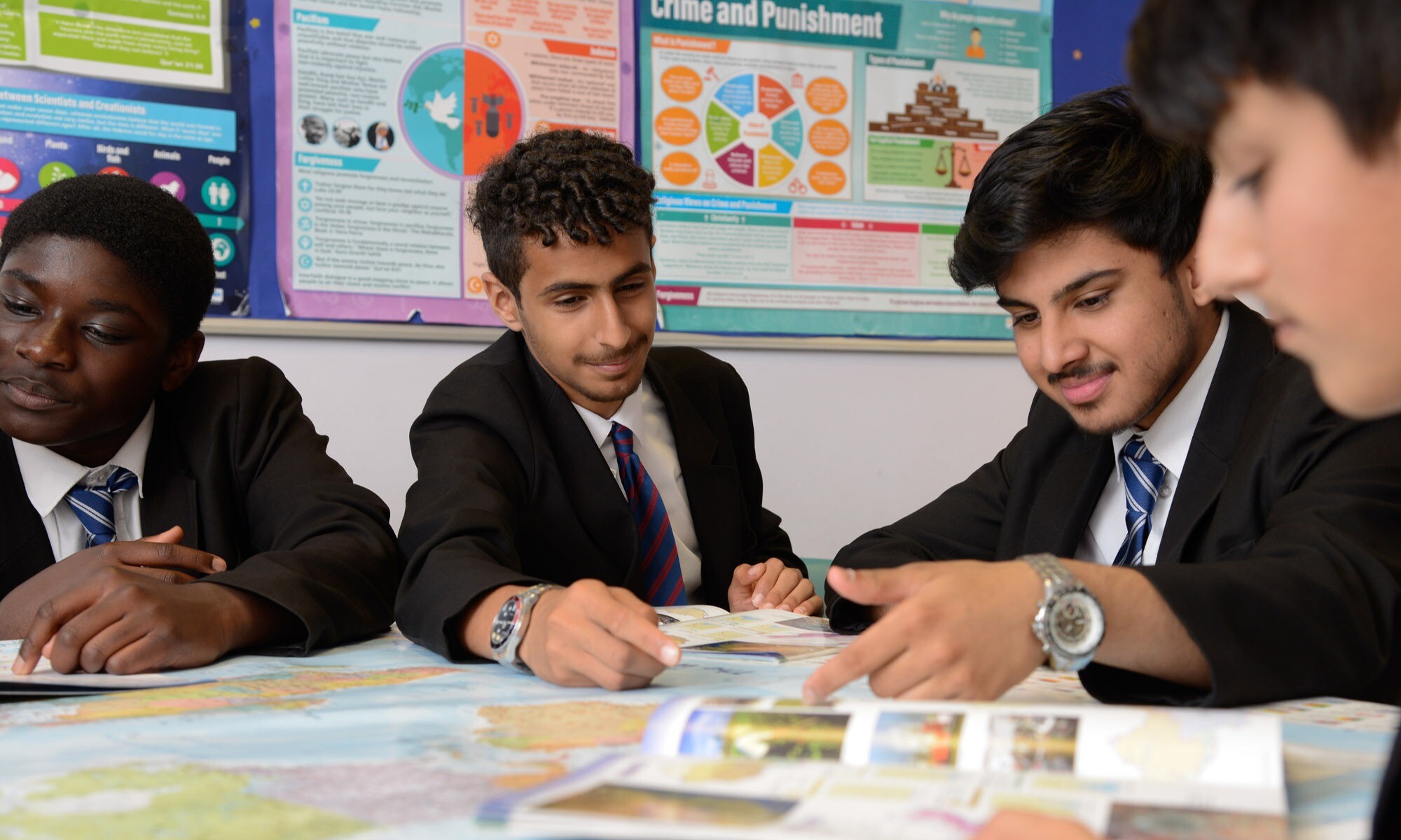 Students in a geography lesson reading a text book