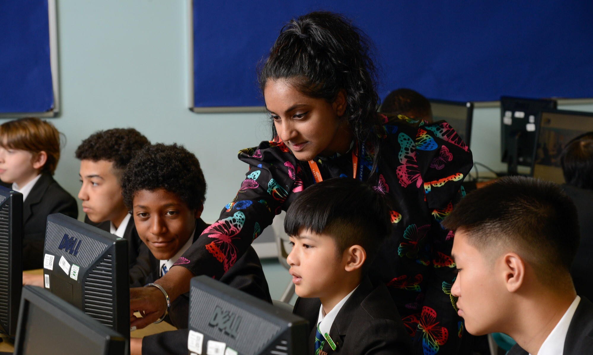 A computer science teacher speaking to a group of students